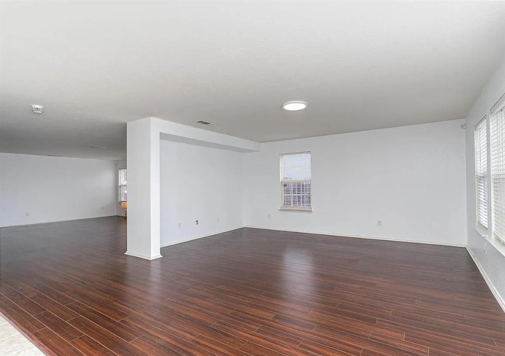 2743 Cold Water Trail Grand Prairie, TX 75052 - Photo 3 of 20 a view of an empty room with wooden floor and a window