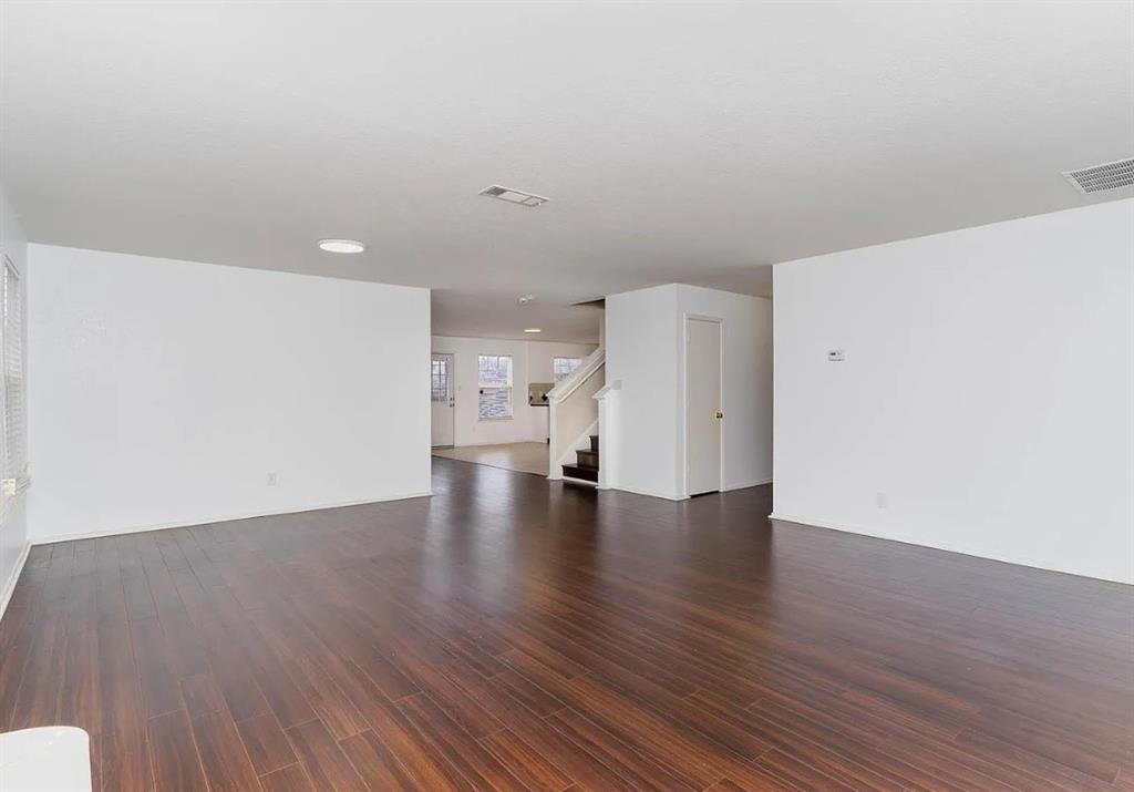 2743 Cold Water Trail Grand Prairie, TX 75052 - Photo 5 of 20 a view of an empty room with wooden floor and a window