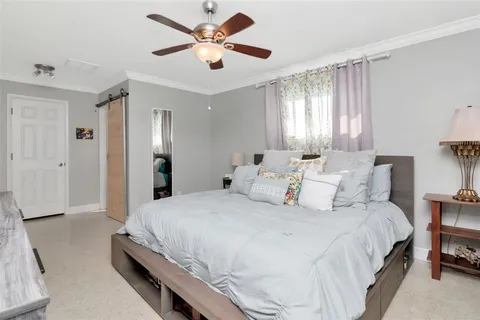 a bedroom with two beds and a chandelier