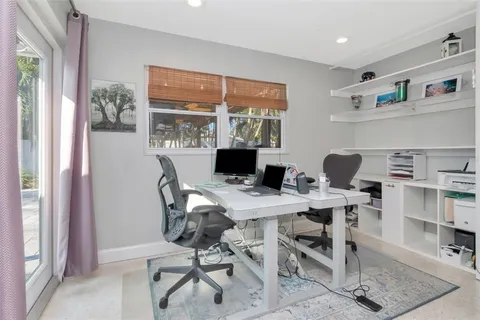 a view of a house with swimming pool and sitting area