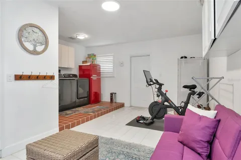 a view of a patio with couches table and chairs and potted plants