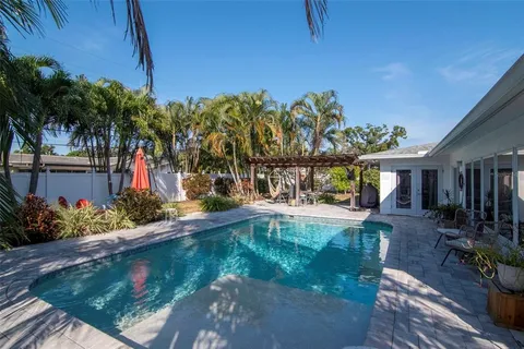 a backyard of a house with table and chairs