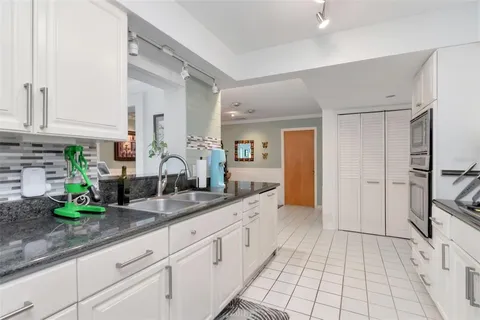 a kitchen with stainless steel appliances granite countertop a sink and cabinets