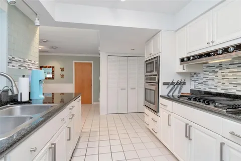 a dining room with furniture a chandelier and wooden floor
