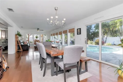 a living room with furniture and floor to ceiling windows