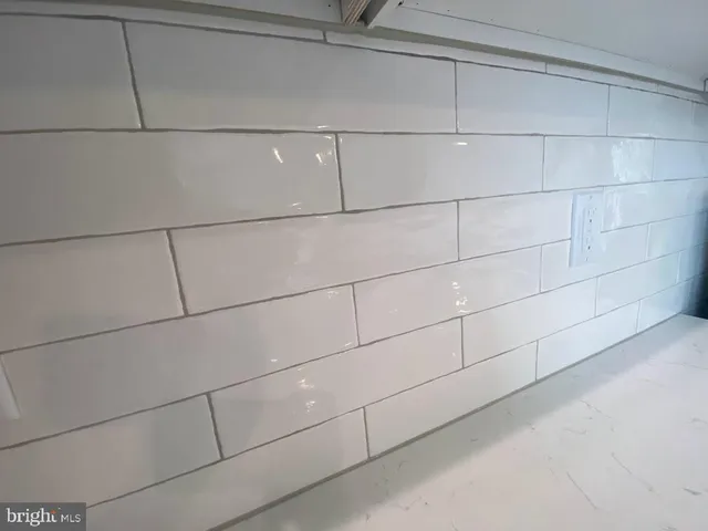 a kitchen with stainless steel appliances kitchen island granite countertop a sink a microwave a center island and cabinets