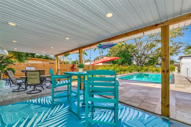 a view of a pool with an outdoor space and seating area