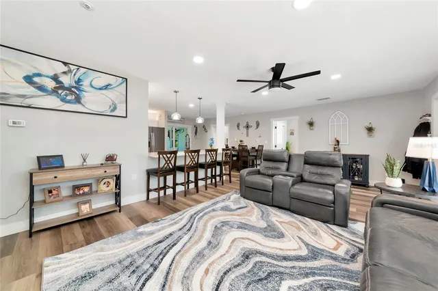 a kitchen with kitchen island white cabinets and stainless steel appliances
