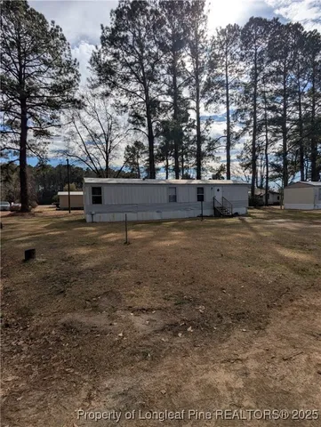a view of yard with large trees