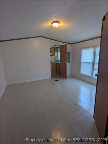 a view of a room with wooden floor