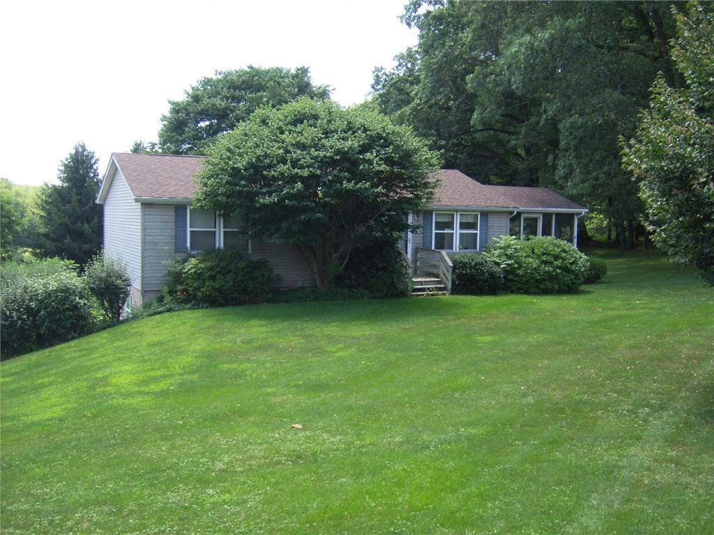130 West Liberty Road Slippery Rock, PA 16057 - Photo 1 of 14 a view of a house next to a big yard and large trees