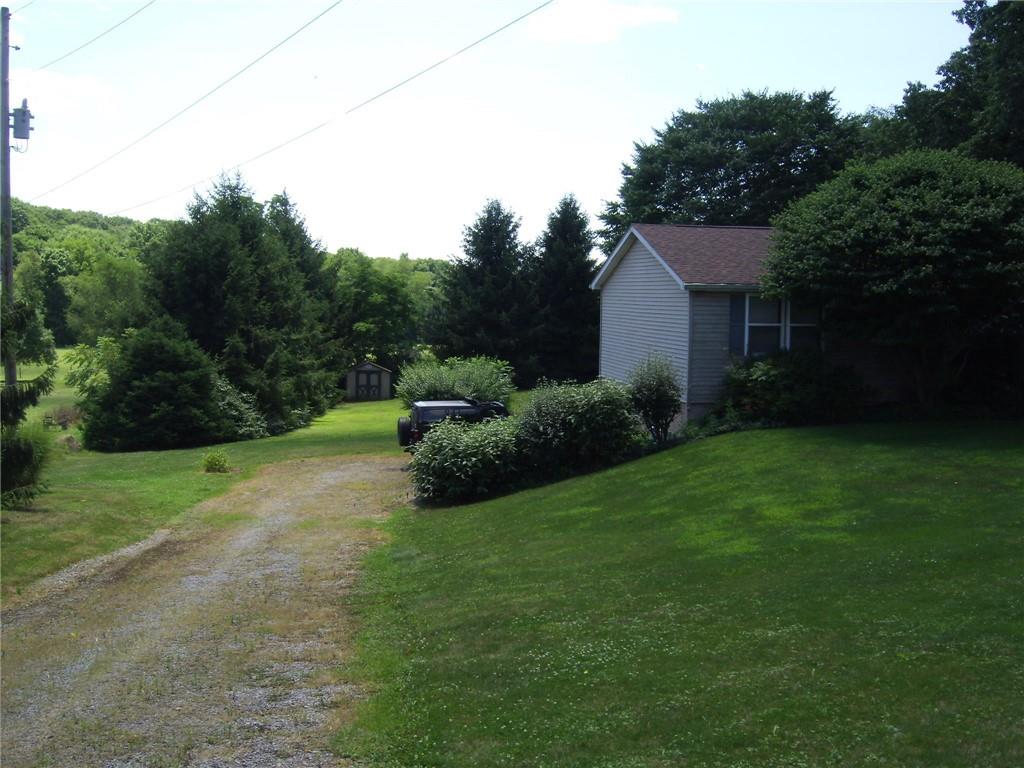 130 West Liberty Road Slippery Rock, PA 16057 - Photo 4 of 14 a backyard of a house with plants and large trees