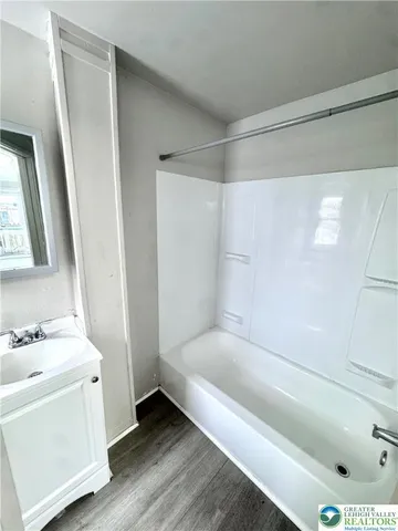 a bathroom with a bathtub and a sink