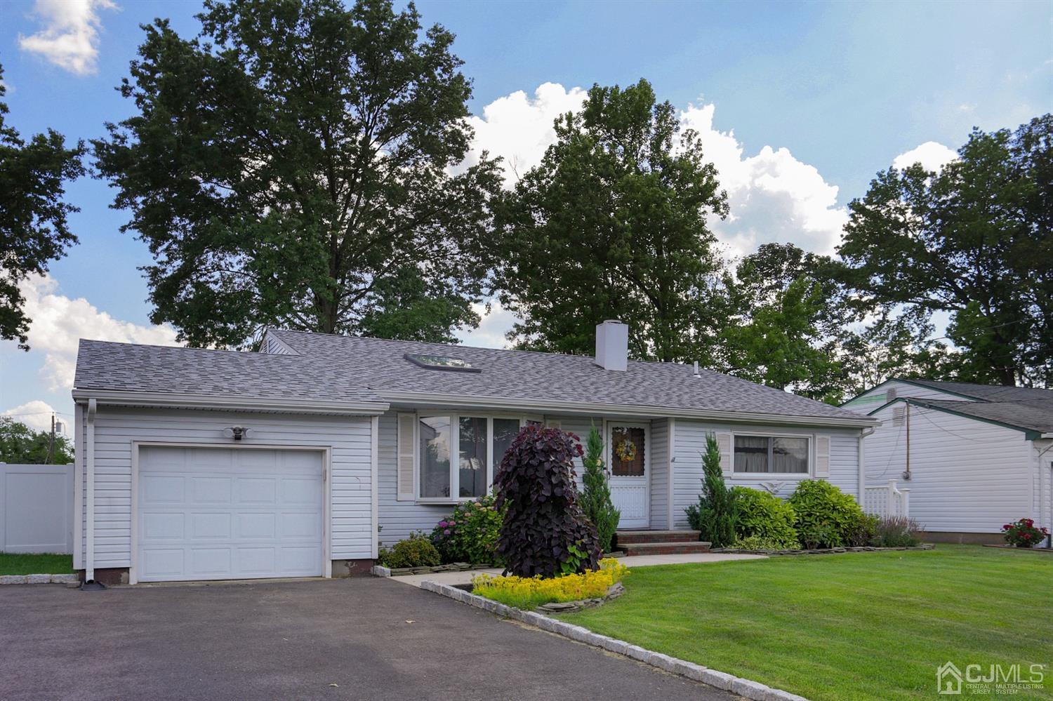 103 Westminster Road Colonia, NJ 07067 - Photo 1 of 26 a front view of a house with garden