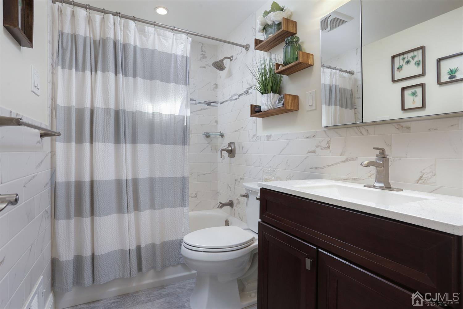 103 Westminster Road Colonia, NJ 07067 - Photo 14 of 26 a bathroom with a sink a toilet and shower