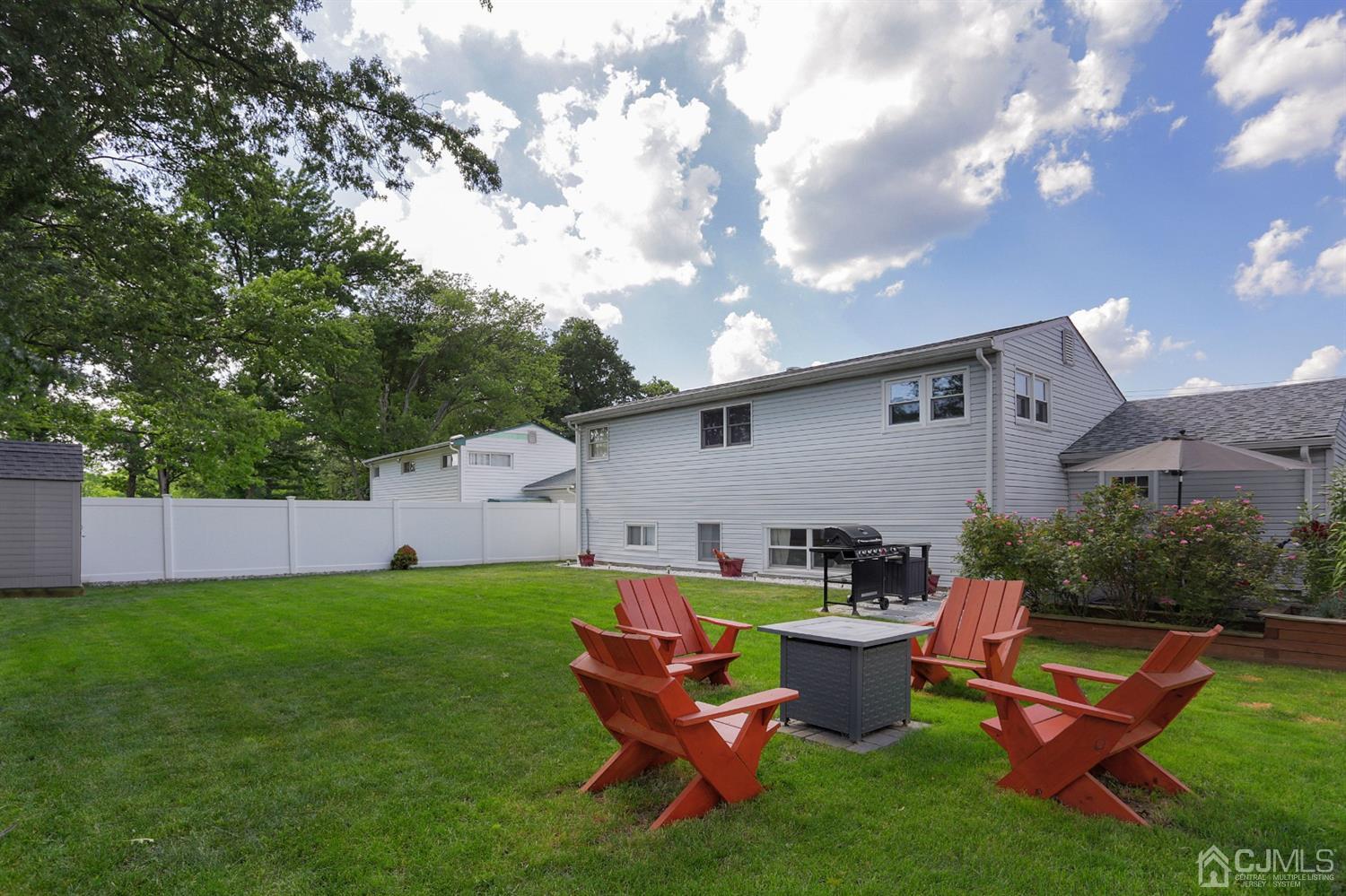103 Westminster Road Colonia, NJ 07067 - Photo 22 of 26 a backyard of a house with table and chairs
