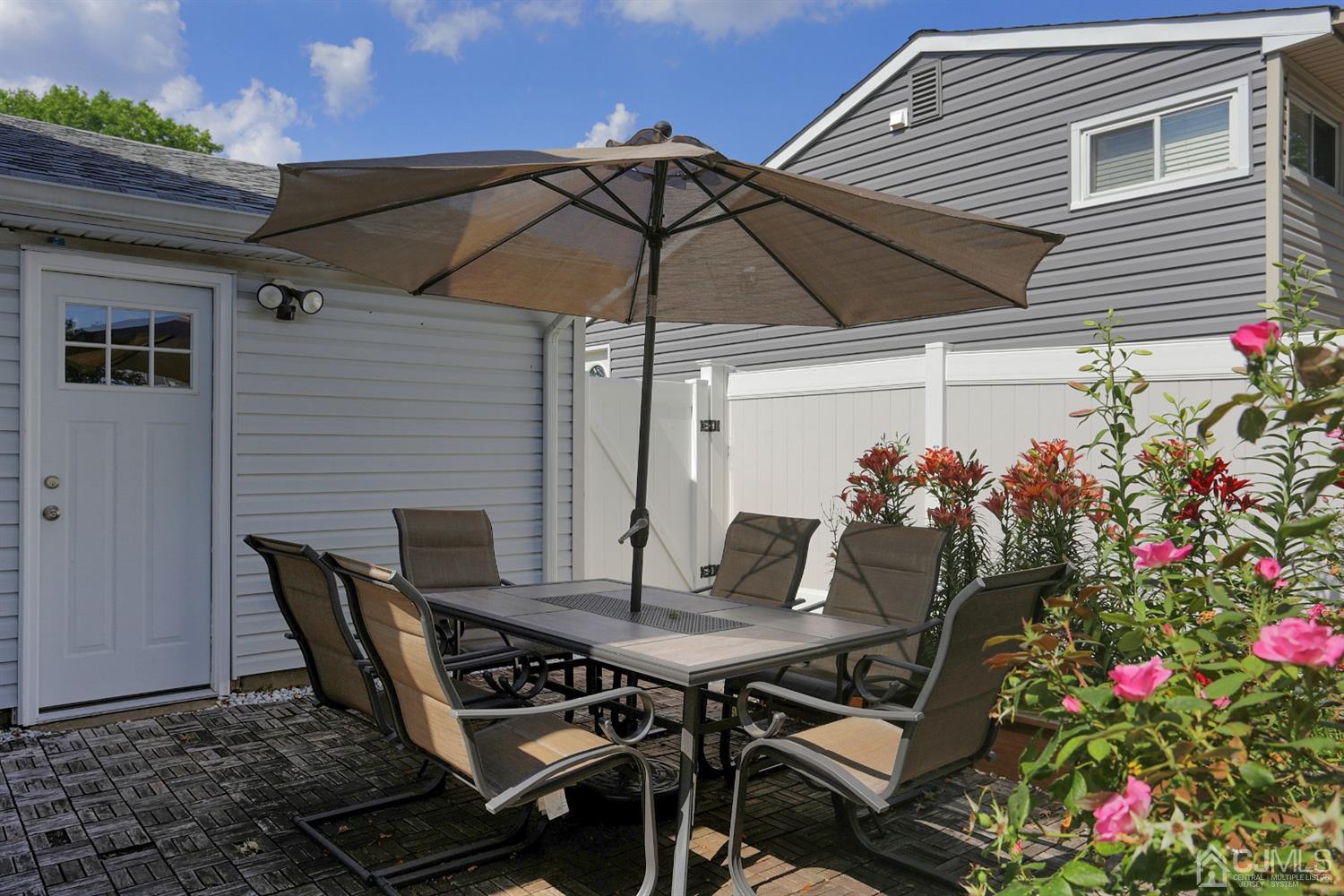 103 Westminster Road Colonia, NJ 07067 - Photo 23 of 26 a outdoor dining space with furniture and umbrella