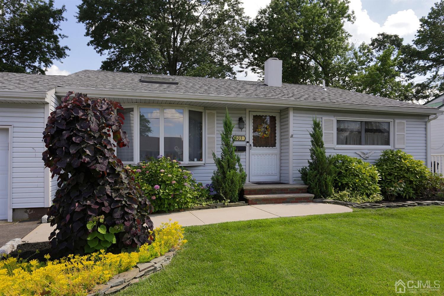 103 Westminster Road Colonia, NJ 07067 - Photo 4 of 26 a front view of a house with a garden