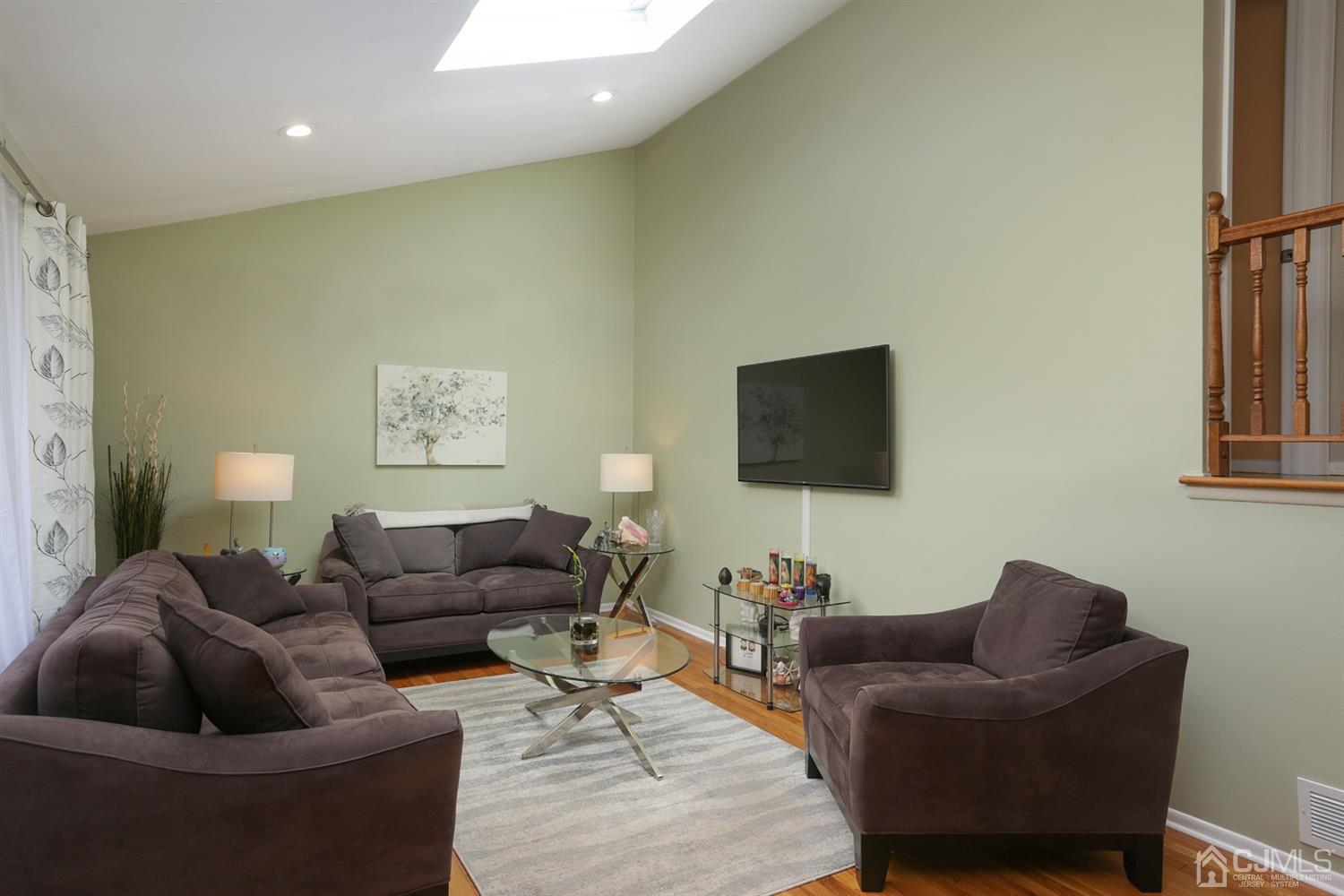 103 Westminster Road Colonia, NJ 07067 - Photo 6 of 26 a living room with furniture and a flat screen tv