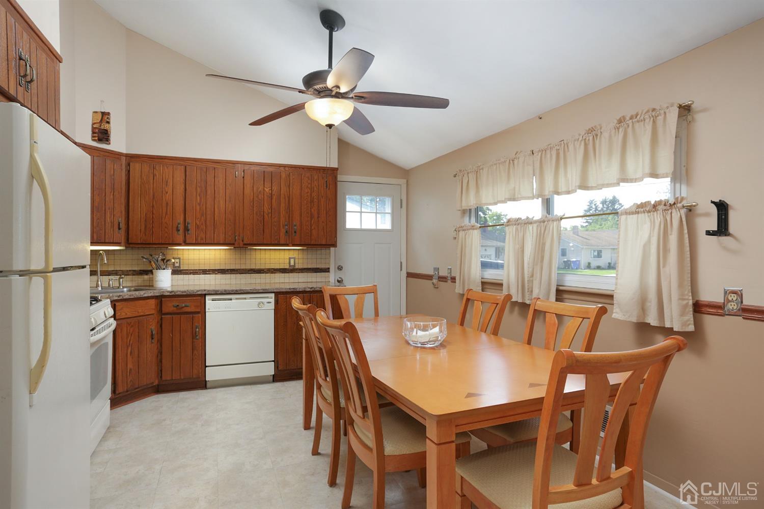 103 Westminster Road Colonia, NJ 07067 - Photo 9 of 26 a kitchen with stainless steel appliances granite countertop a table chairs and a refrigerator