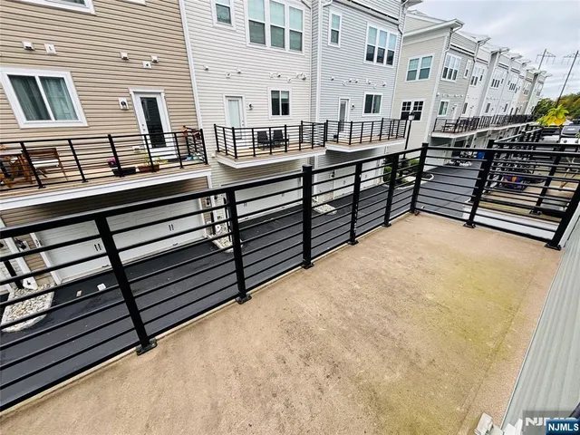 a view of a balcony with two chairs and a wooden floor