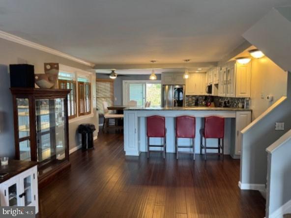 1355 Forrest Street Trainer, PA 19061 - Photo 12 of 37 a kitchen with stainless steel appliances granite countertop a stove top oven a sink a dining table and chairs with wooden floor