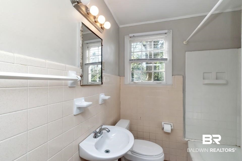 5001 Hillwood Circle South Mobile, AL 36608 - Photo 15 of 20 Bathroom featuring ornamental molding, a sink, toilet, and shower / bathing tub combination