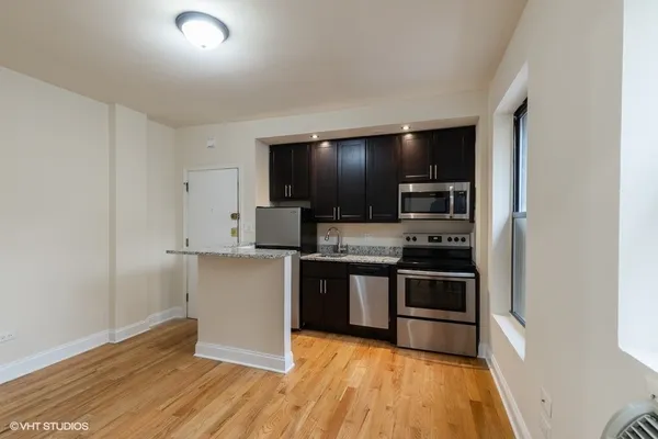 a kitchen with stainless steel appliances granite countertop a stove top oven and sink