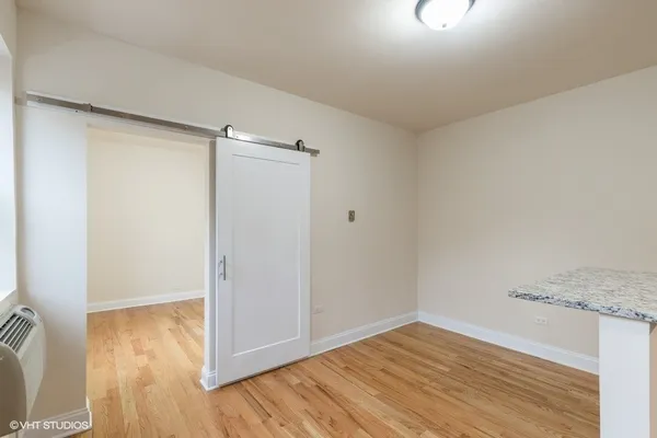 an empty room with wooden floor