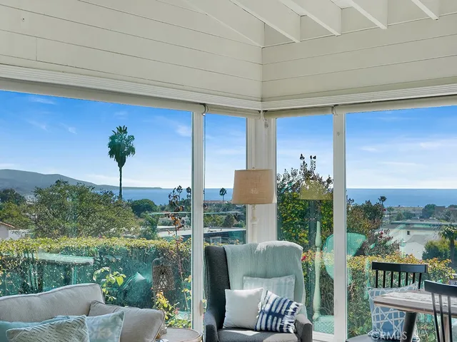 a front view of a house with a couple of chairs