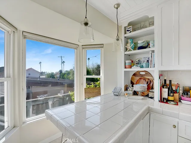 a kitchen with stainless steel appliances granite countertop a sink and a refrigerator