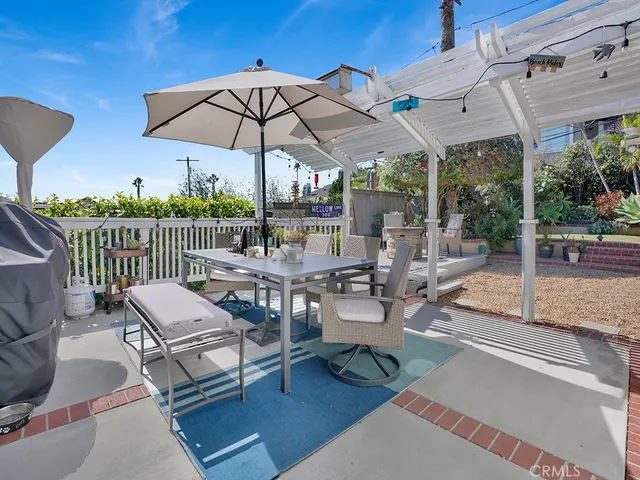 a view of a patio with a table and chairs under an umbrella