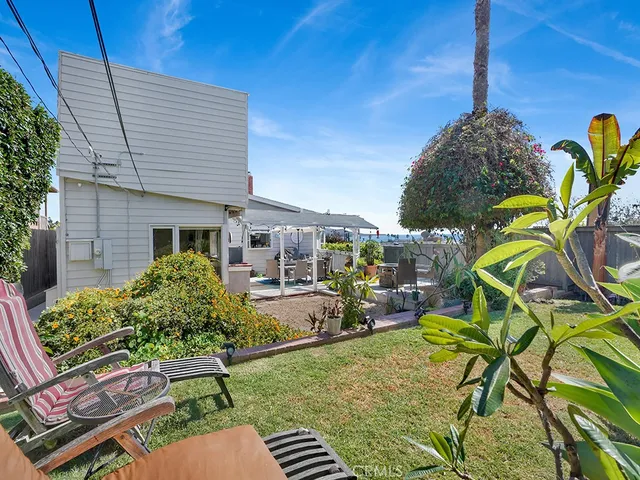 a view of a patio with table and chairs potted plants with wooden fence