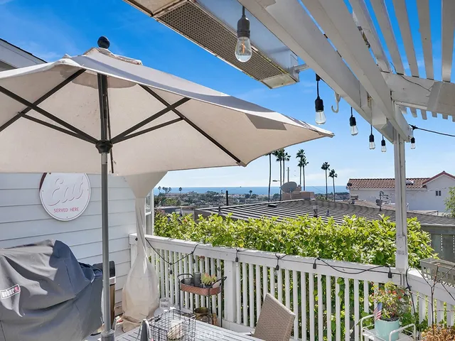 a view of a chair and tables in the balcony
