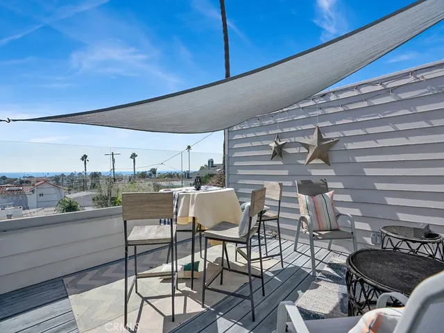 a view of a chairs and table in the balcony