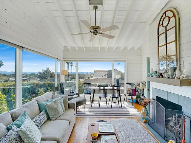a living room with fireplace furniture and a floor to ceiling window