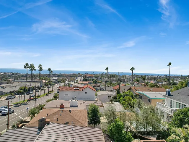 an aerial view of a house with garden space and parking