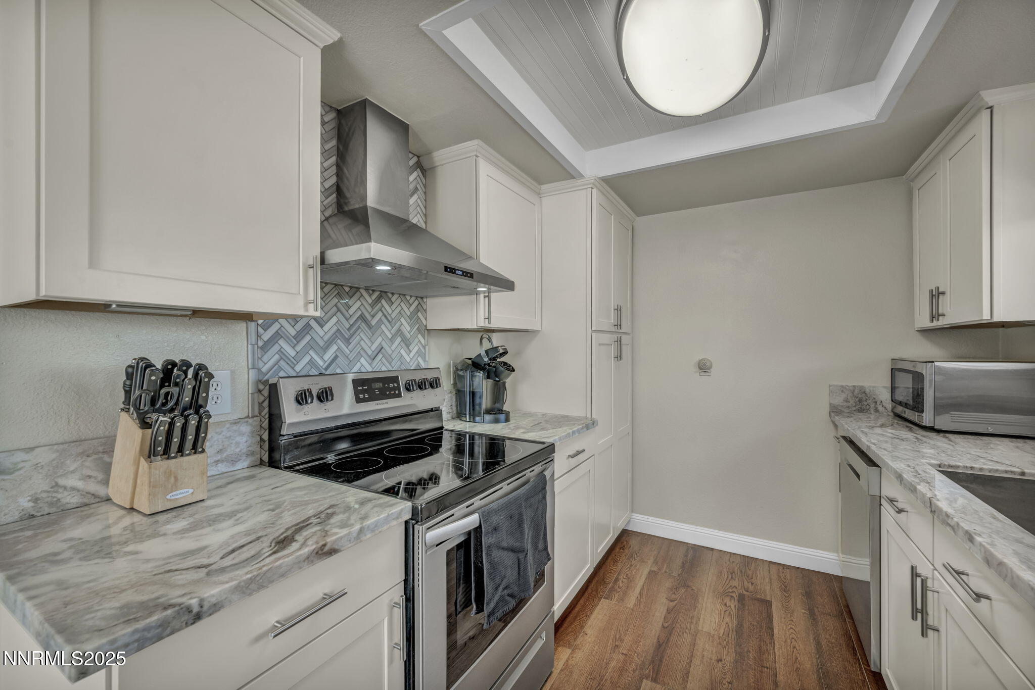 707 Addler Road Gardnerville, NV 89460 - Photo 28 of 72 a kitchen with granite countertop a stove and a sink