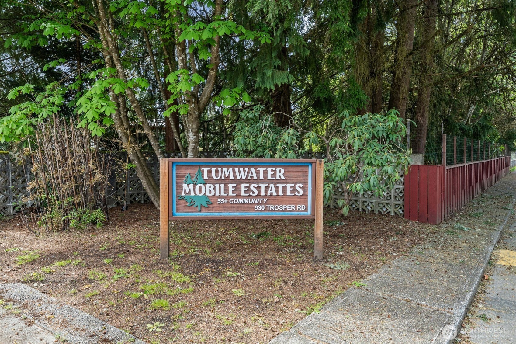930 Trosper Road Southwest, Unit 33 Tumwater, WA 98512 - Photo 23 of 26 a sign that is sitting in front of a tree