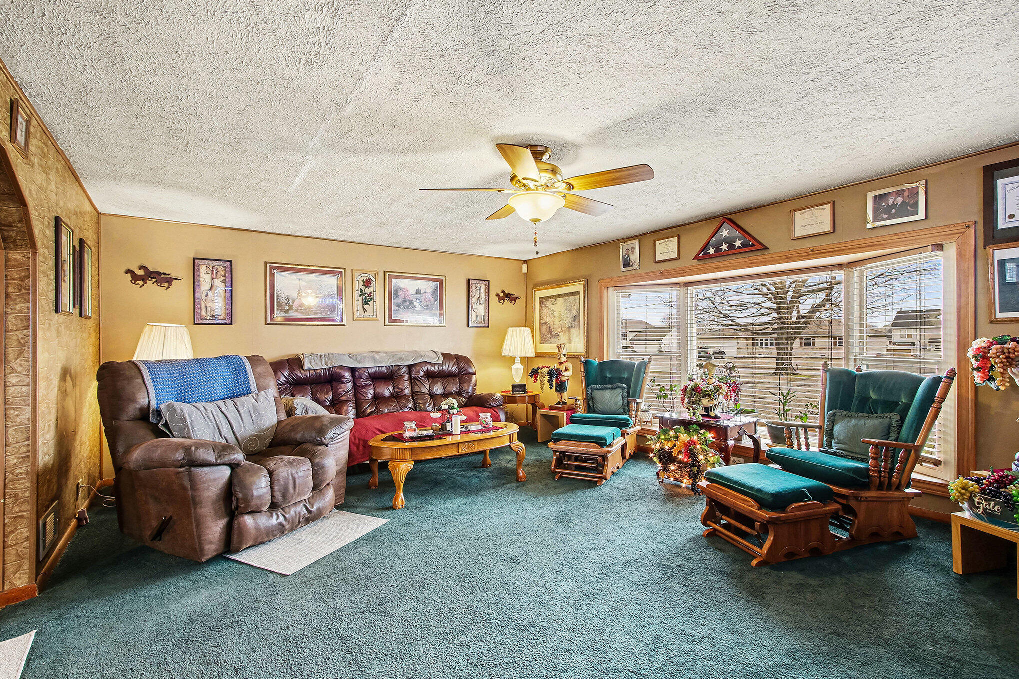 a living room with furniture a flat screen tv and a large window