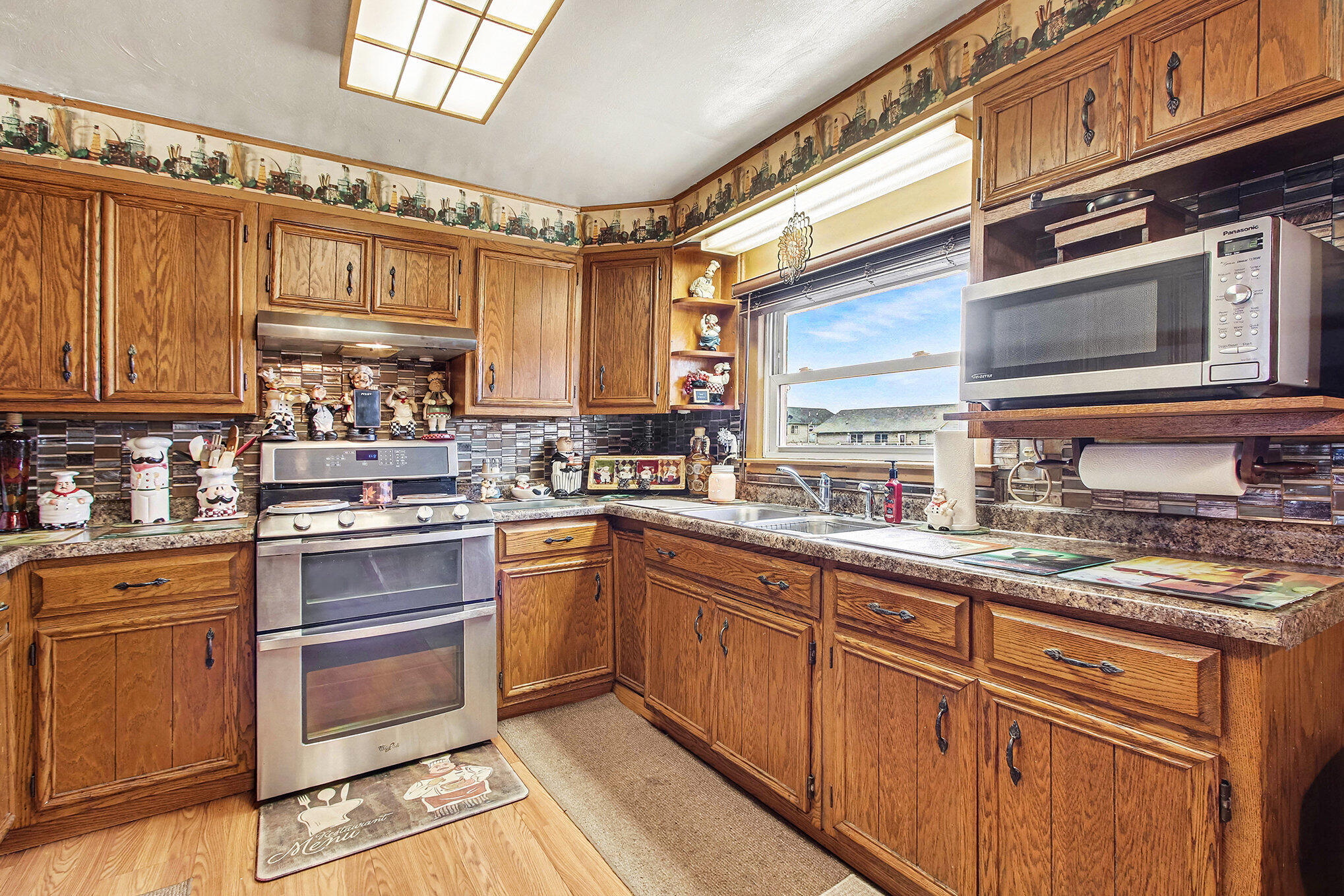 2954 Airport Road Portage, IN 46368 - Photo 2 of 14 a kitchen with stainless steel appliances granite countertop a stove sink and cabinets