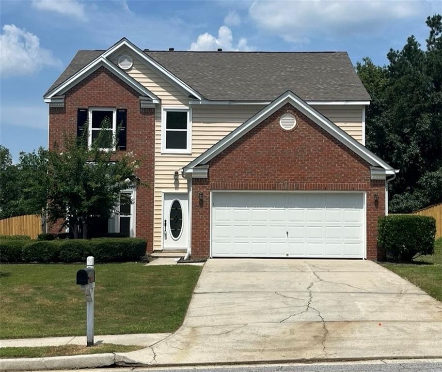 a view of a house with a yard