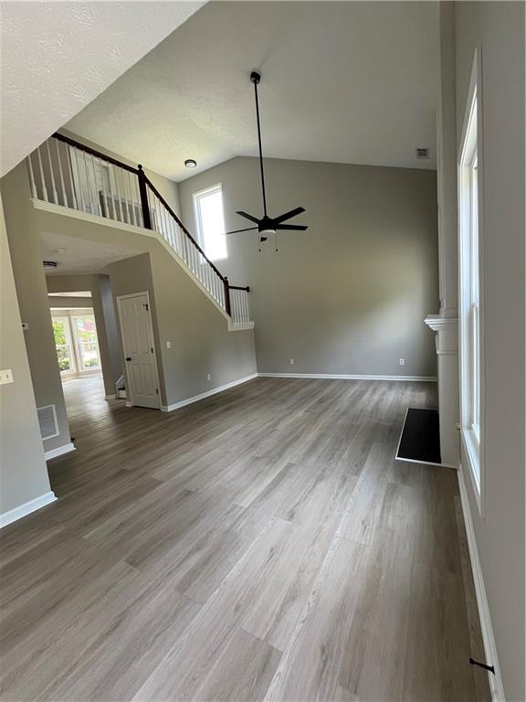 2147 St Albans Place Buford, GA 30519 - Photo 11 of 29 a view of a hallway view with wooden floor and staircase
