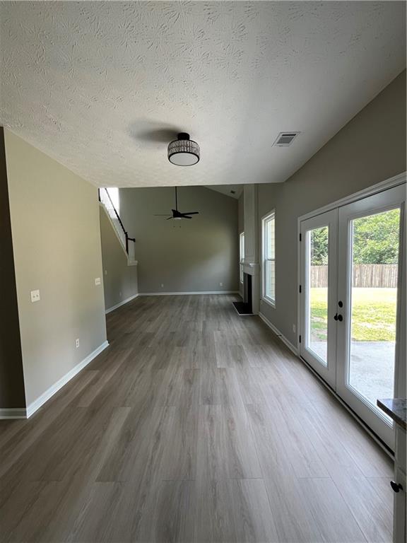 2147 St Albans Place Buford, GA 30519 - Photo 13 of 29 an empty room with wooden floor and windows