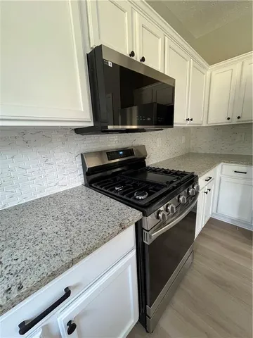 a kitchen with stainless steel appliances and cabinets
