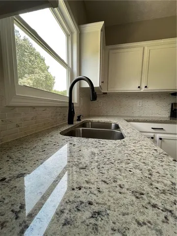 a close view of a sink a counter space and a window