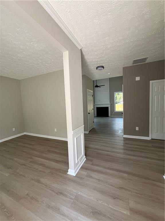 2147 St Albans Place Buford, GA 30519 - Photo 2 of 29 a view of a room with wooden floor