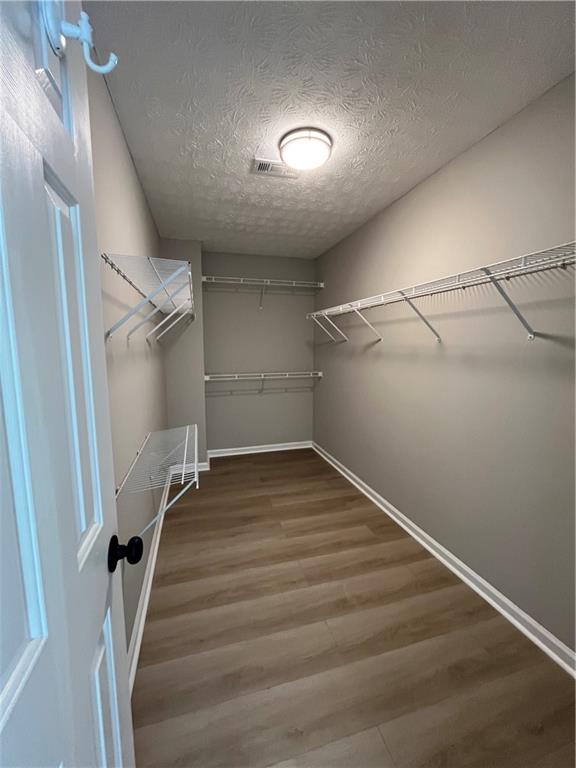 2147 St Albans Place Buford, GA 30519 - Photo 22 of 29 a view of a room with wooden floor and white walls