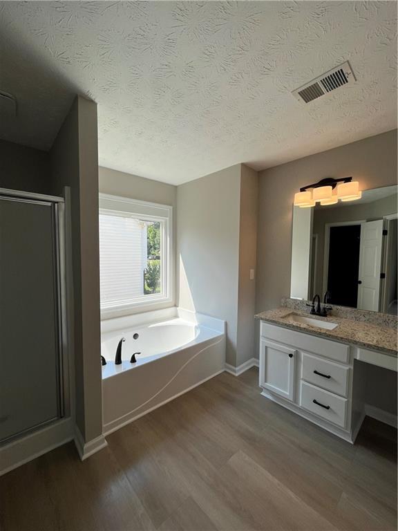 2147 St Albans Place Buford, GA 30519 - Photo 23 of 29 a bathroom with a tub sink and mirror