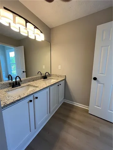 a bathroom with a double vanity sink and a mirror